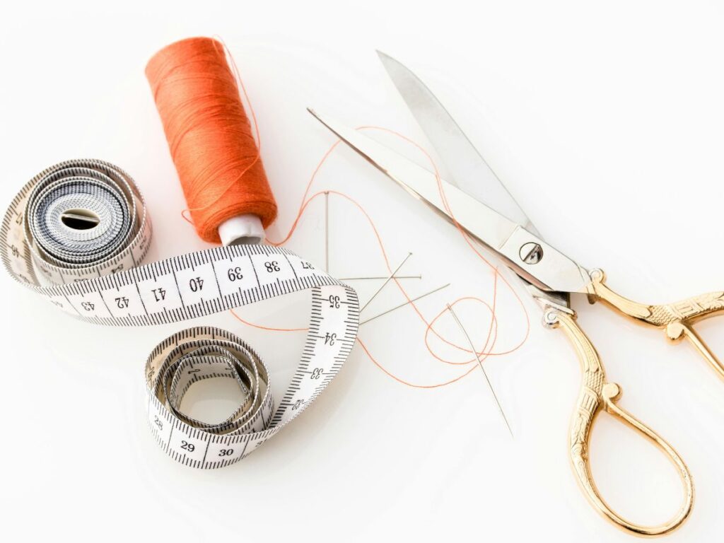 needle scissors and inch tape