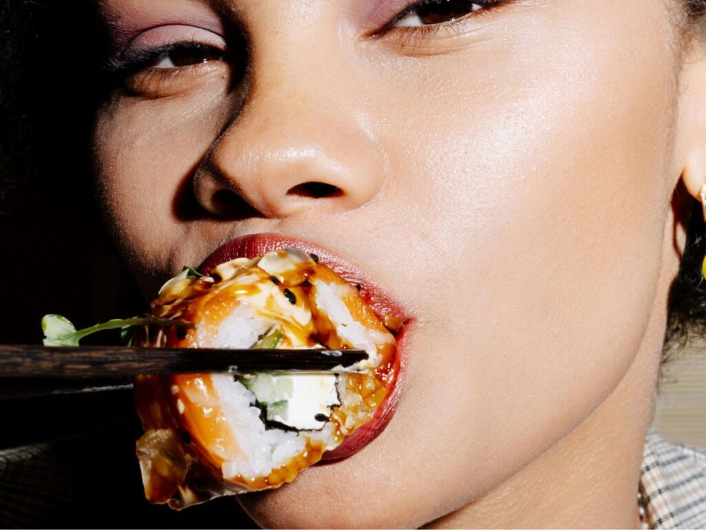 woman eating sushi