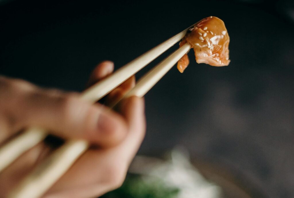 holding sushi in chopstick