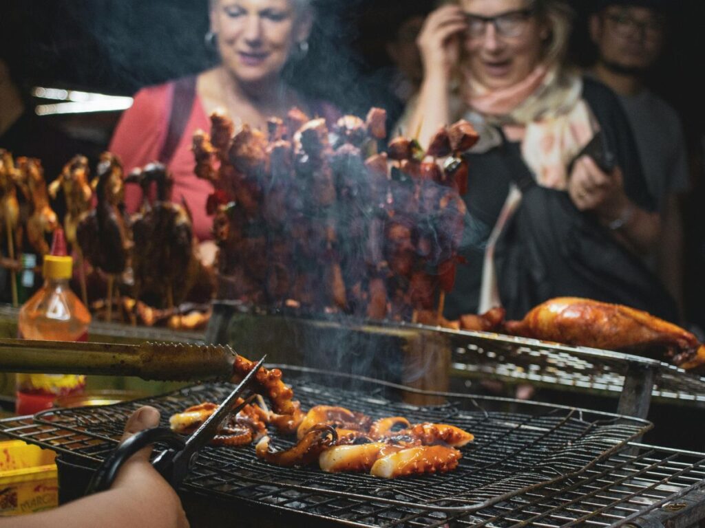 people buying street food bbq