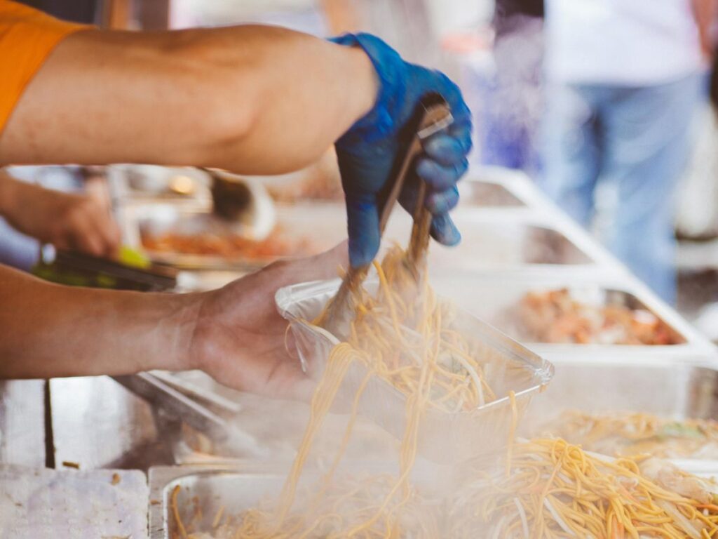 man adding street food