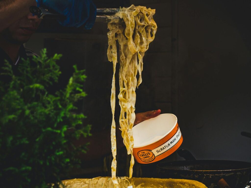 pouring noodles in bowl