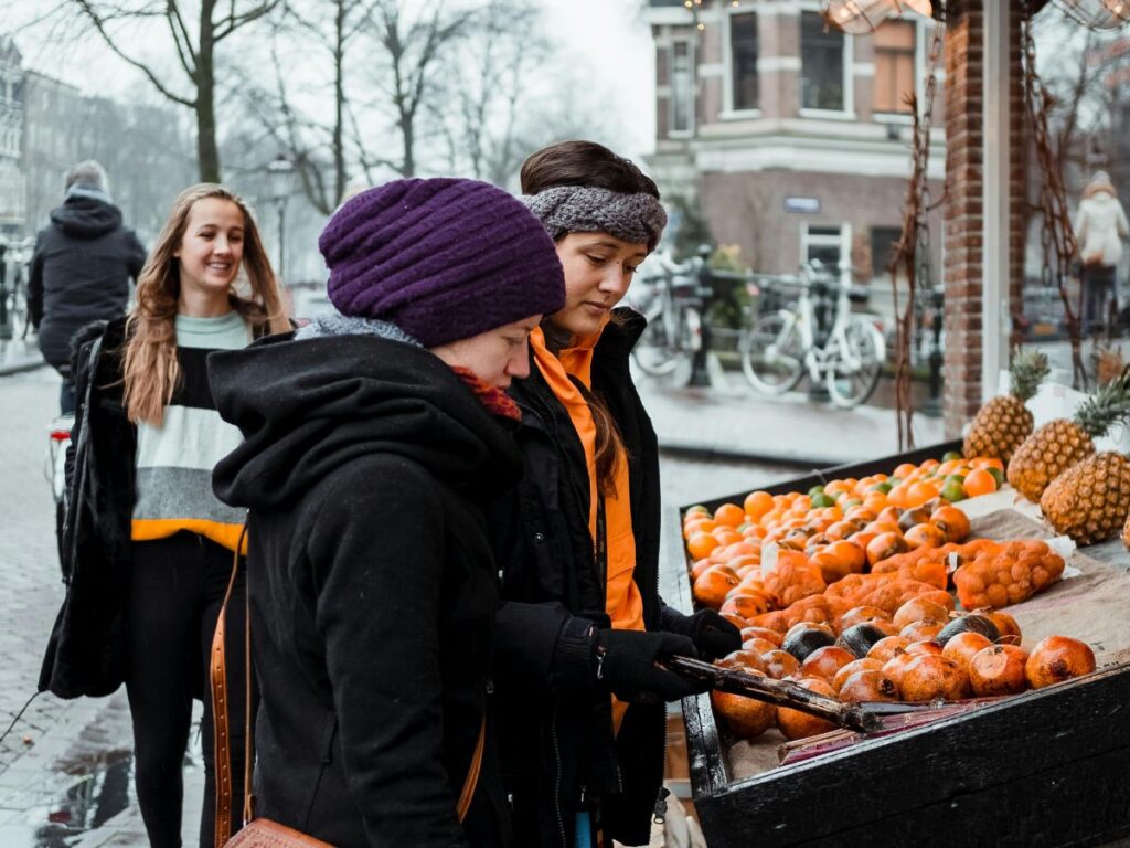 people buying from a street food cart