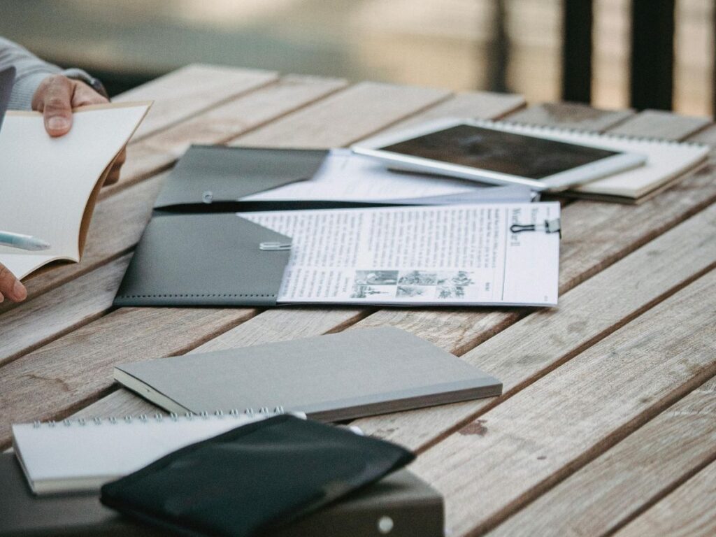 books and laptop on bench