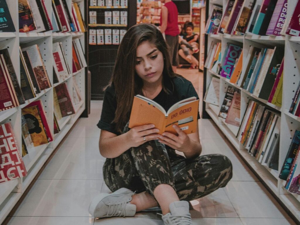 girl reading book in a book store