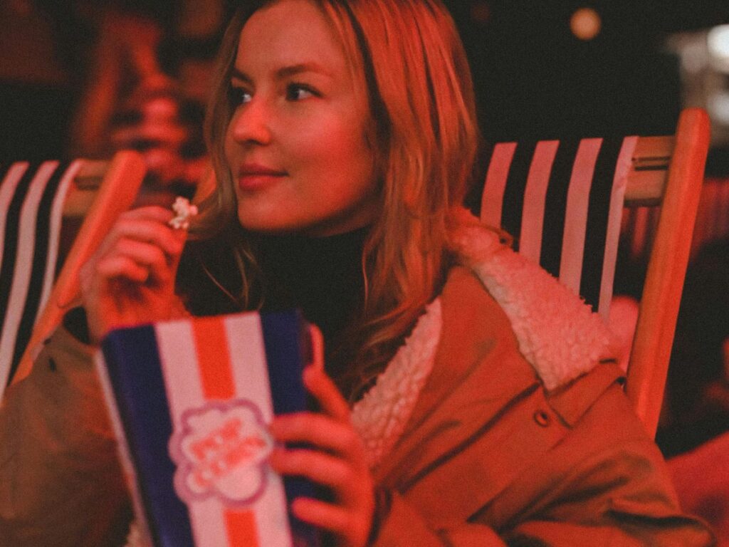 girl eating popcorn in a cinema