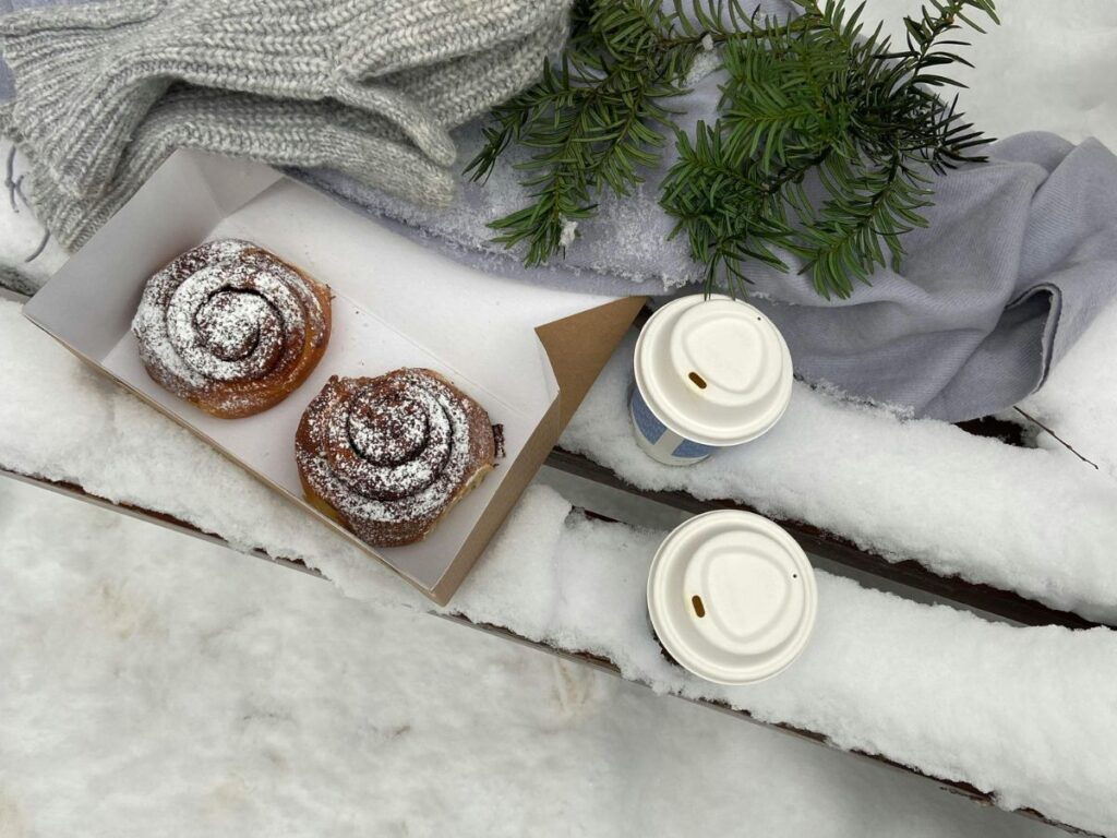 cinnamon rolls with coffee in snow