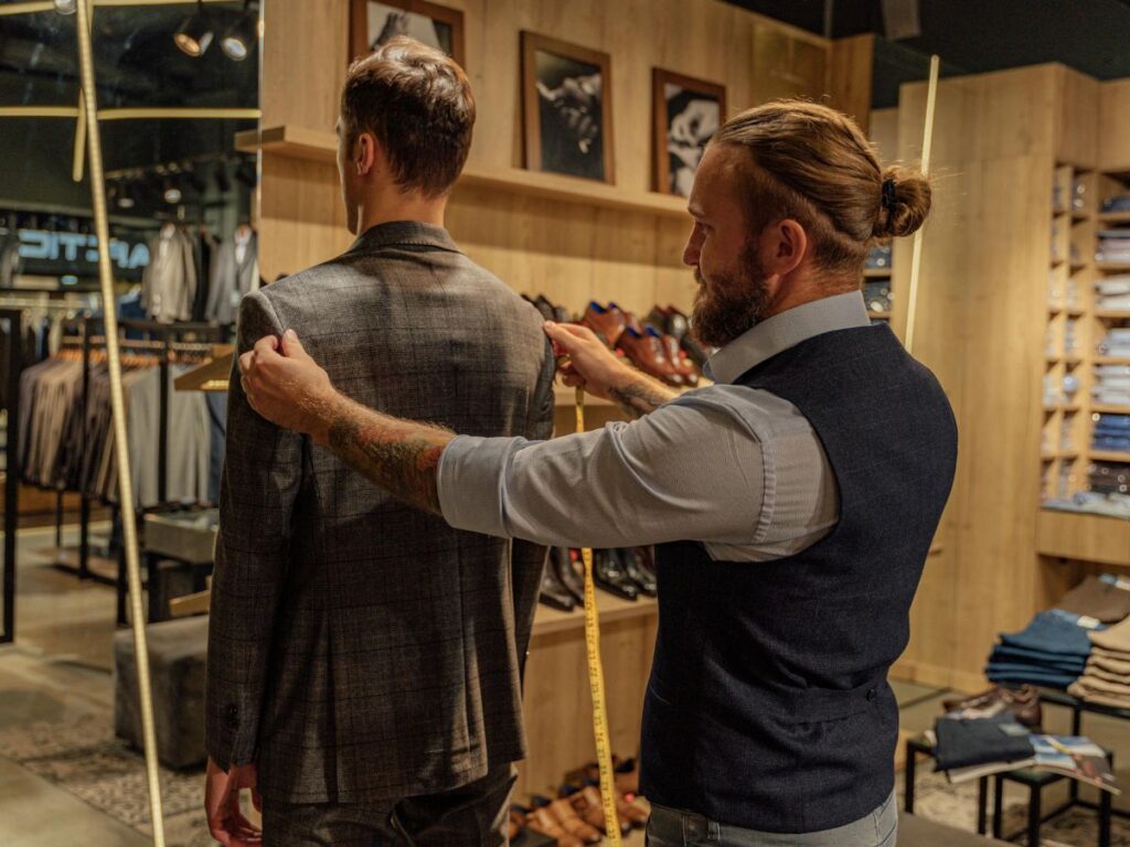 tailor taking measurements for custom suit