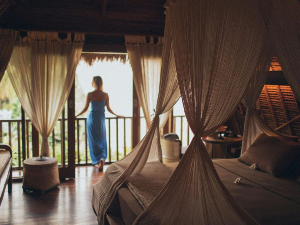 woman standing in hotel room balcony