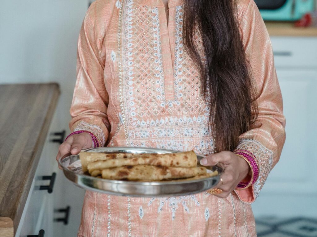 woman holding paratha roll