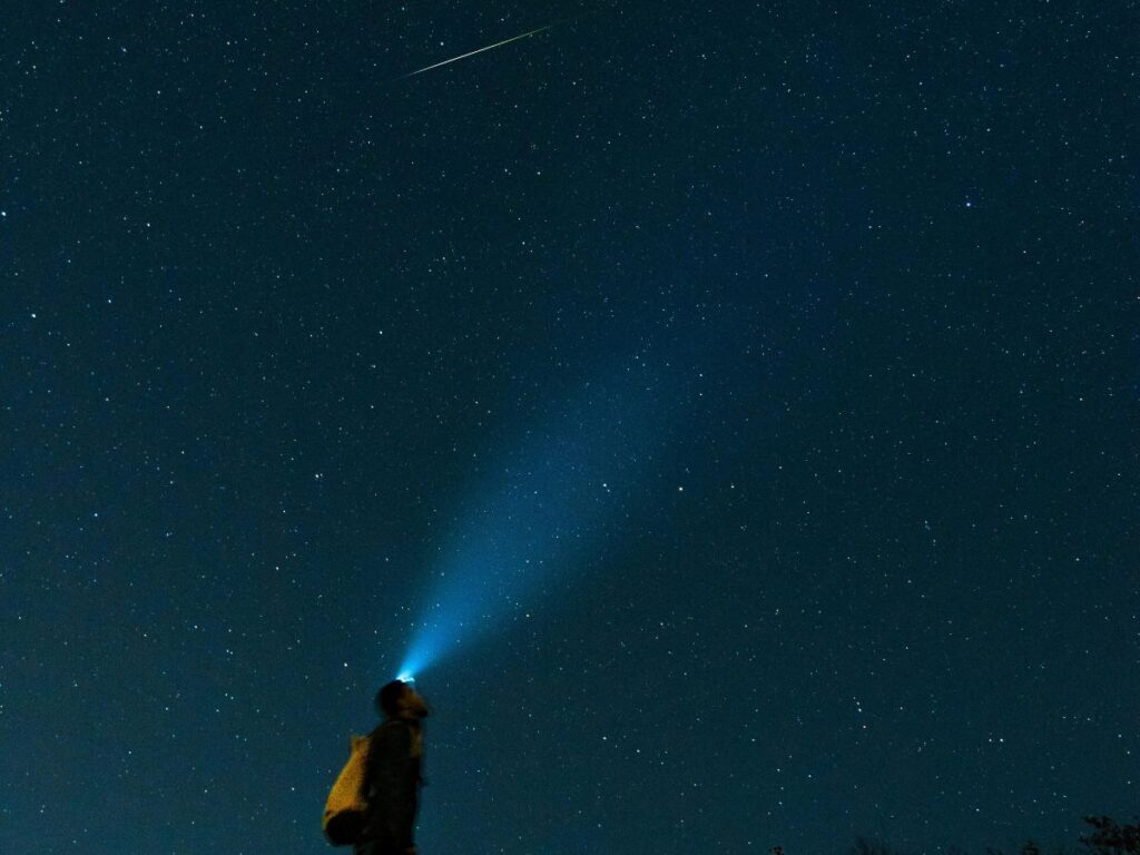 man looking at a shooting star