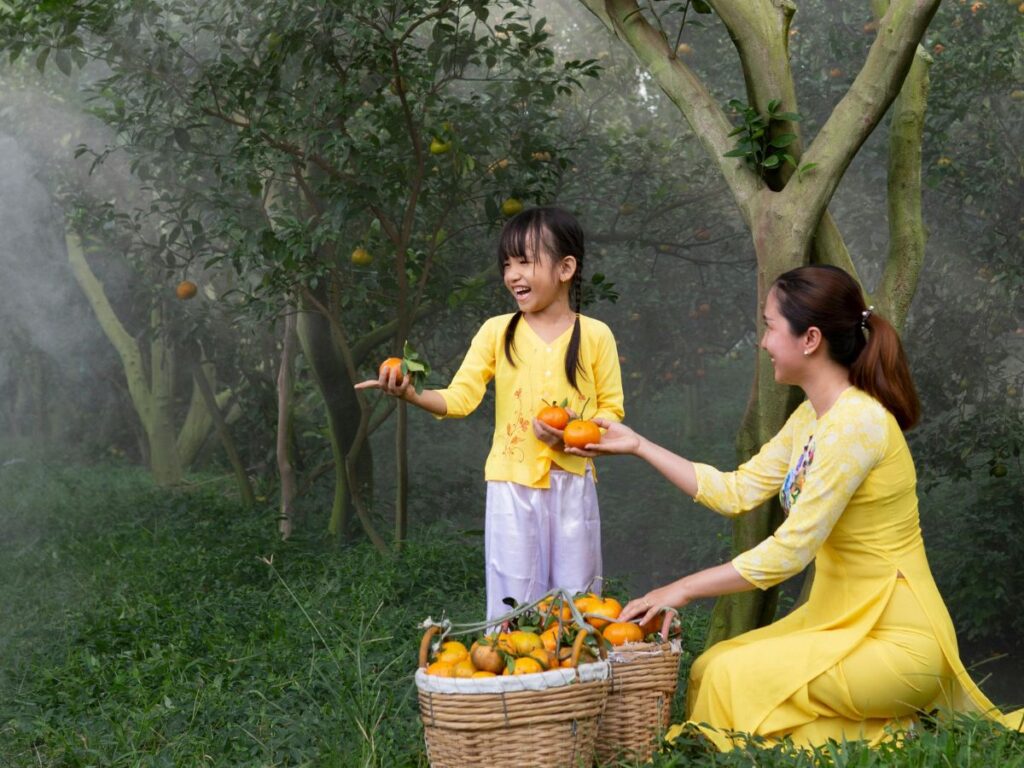 mother and daughter collecting mangoes