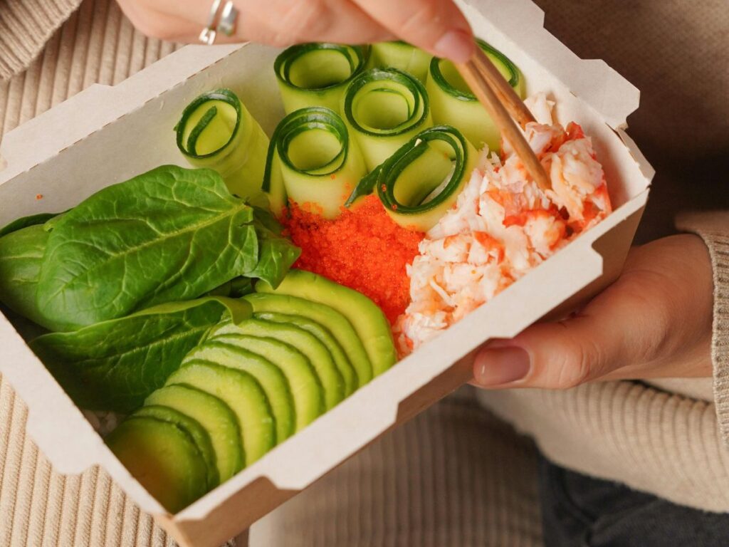 eating sushi in takeout box