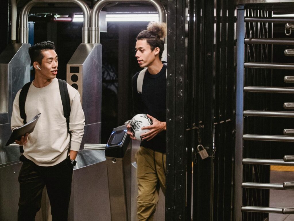 men standing in a subway train 