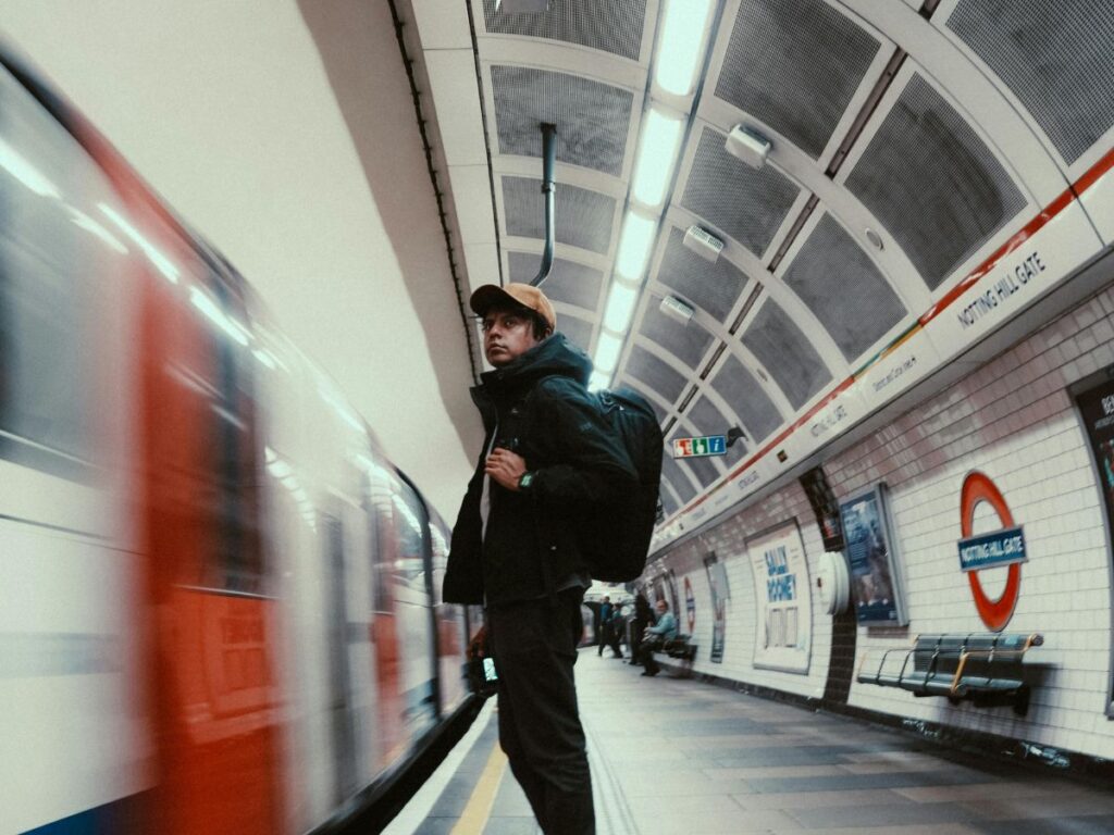 man standing at a transit station