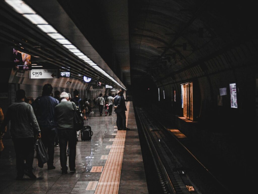 people standing in a transit station