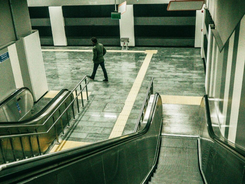 man waiting for train in a transit station