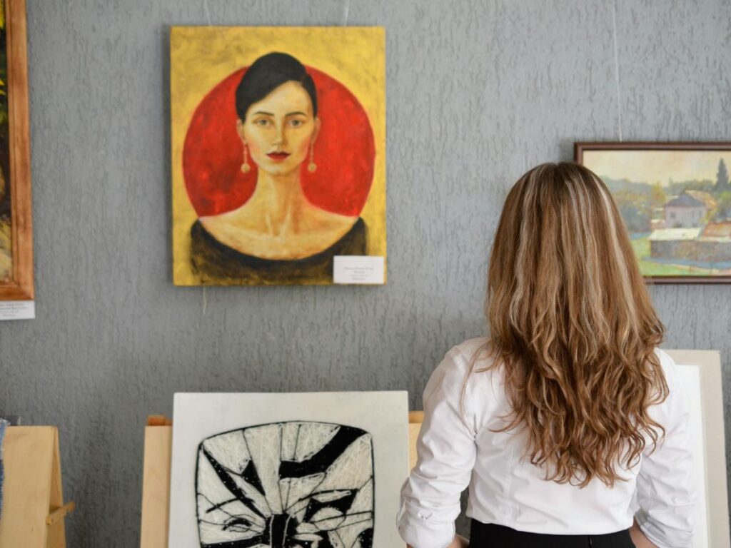 woman looking at art in gallery