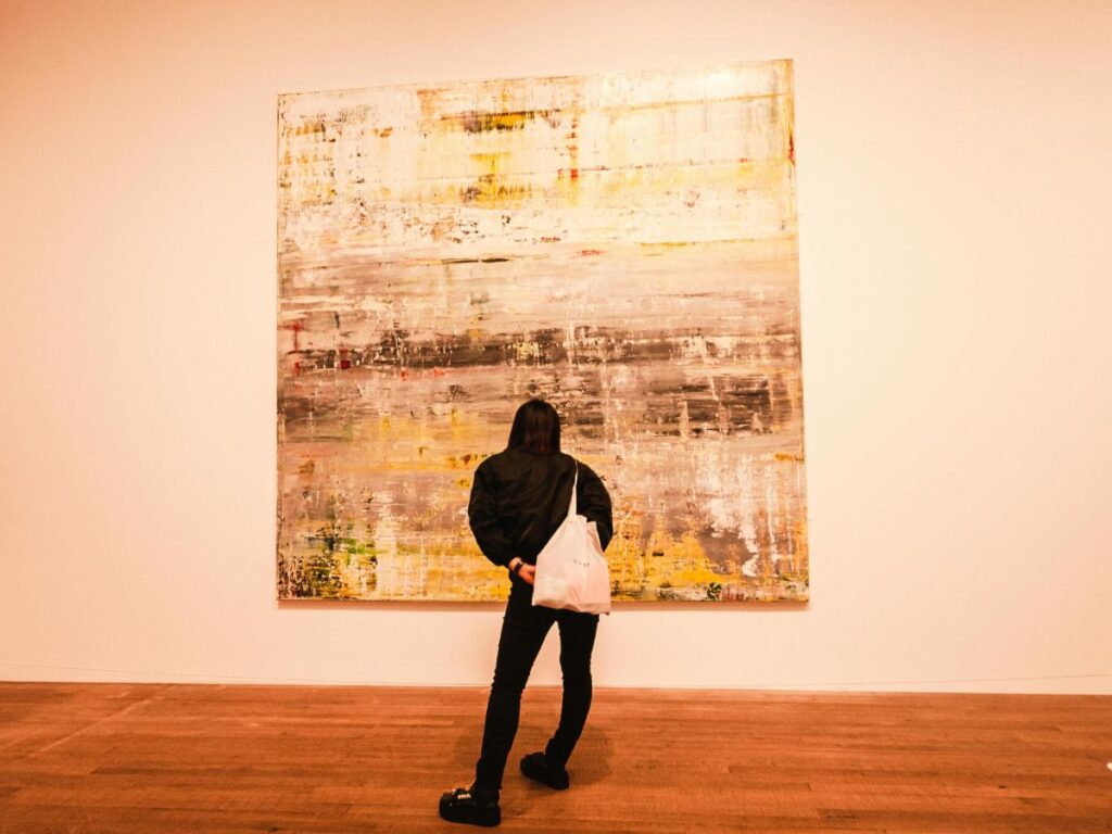 man looking at art in a gallery