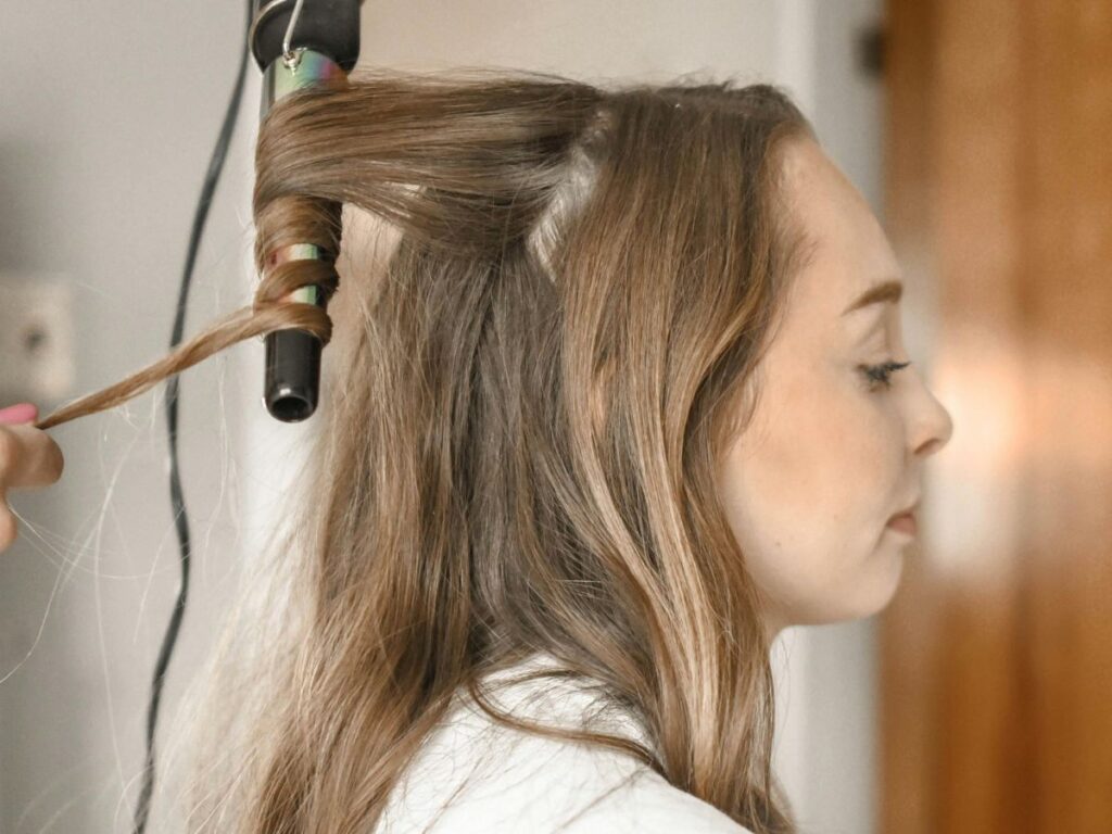 woman getting her hair curled