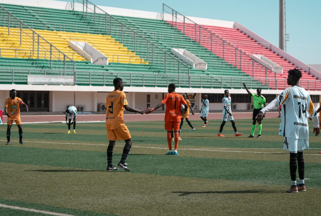 footballers playing in a stadium