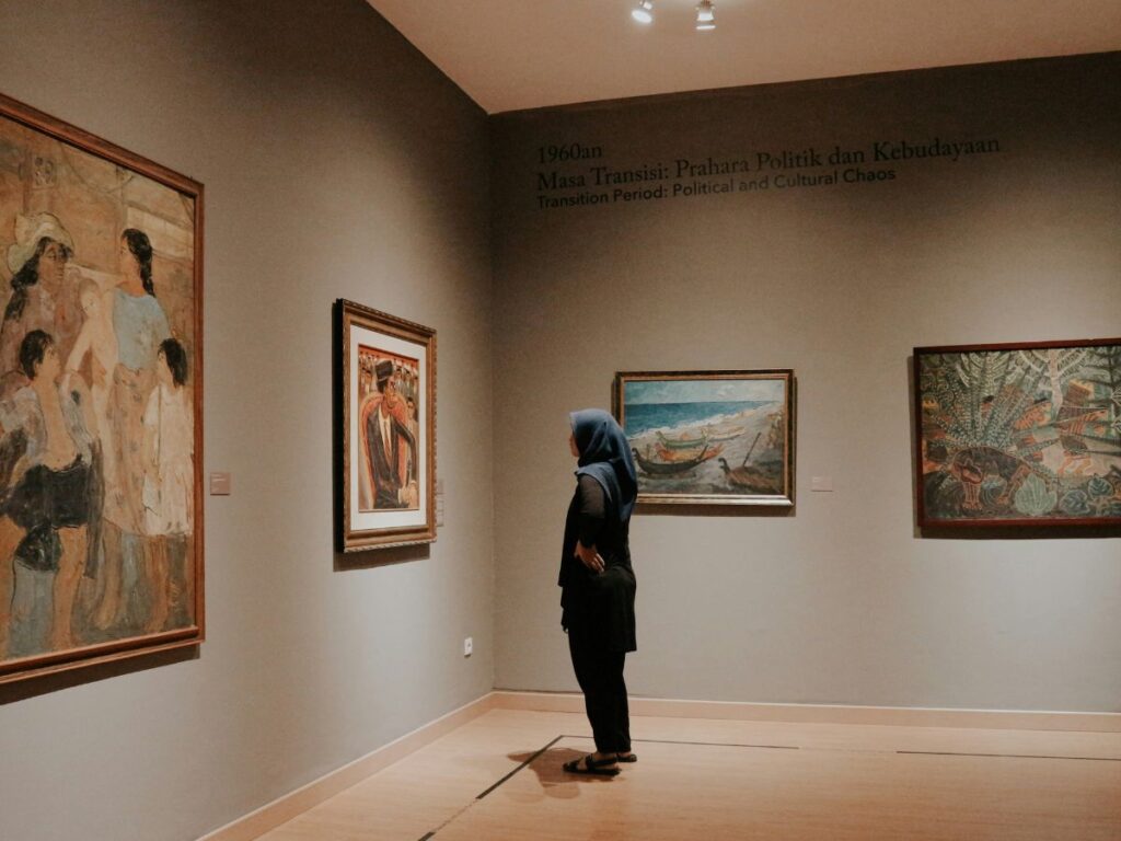 man looking at art