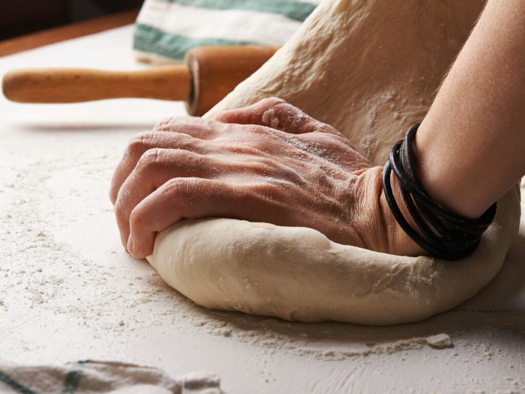 man kneading dough