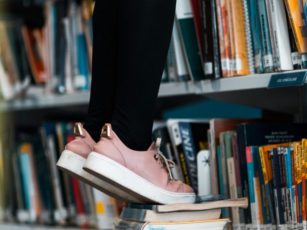 climbing on books in a library