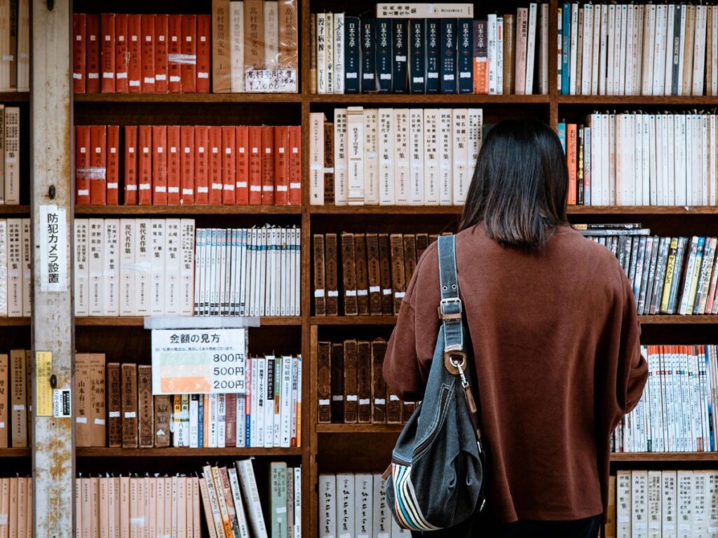 woman choosing a book in a library