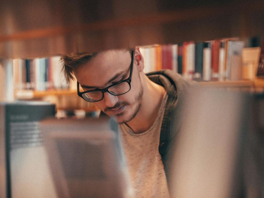 man choosing a book in a library