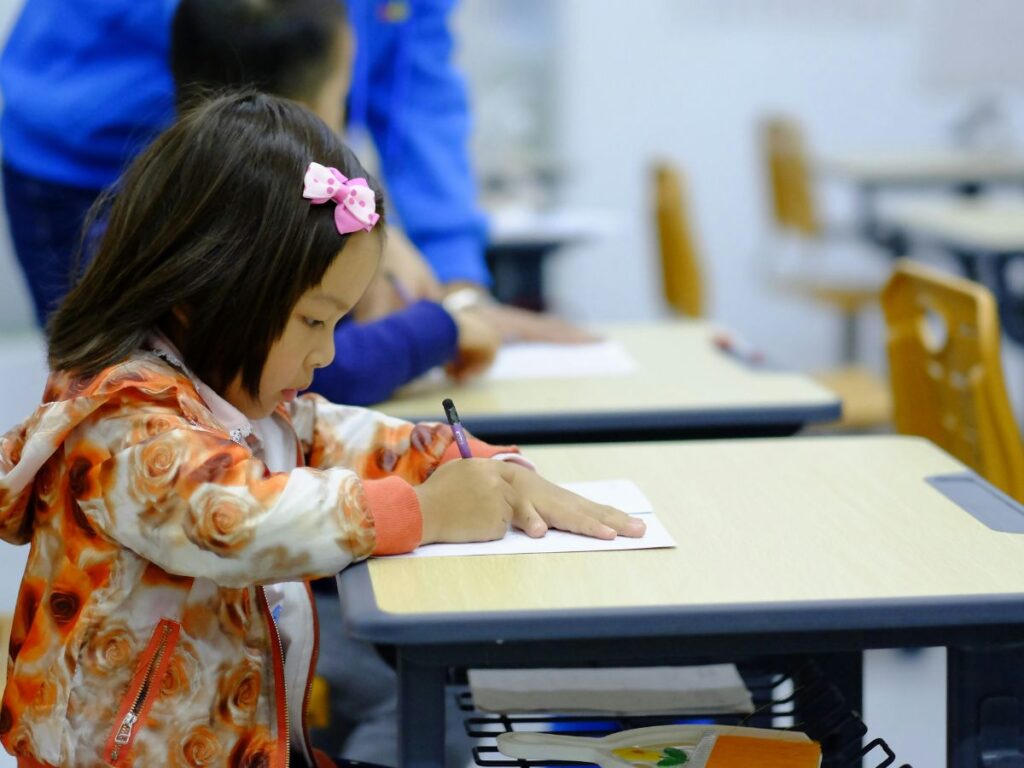 child writing in a school