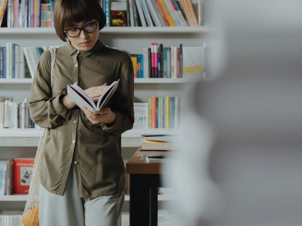 woman reading a book in a bookstore