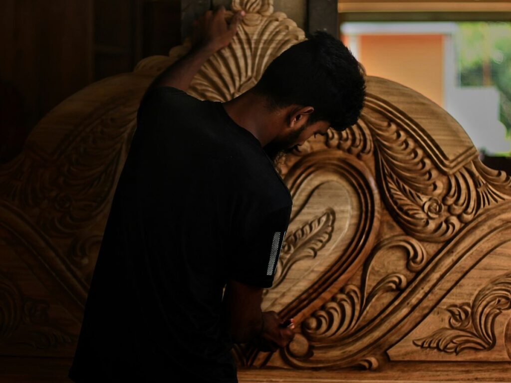 man carving furniture