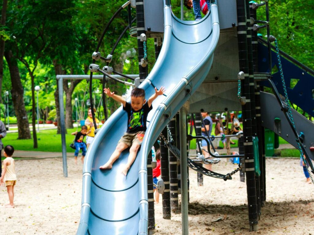 kids on a slide in a park