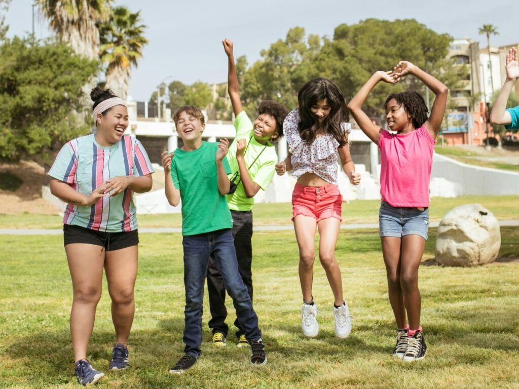 young teens laughing in a park