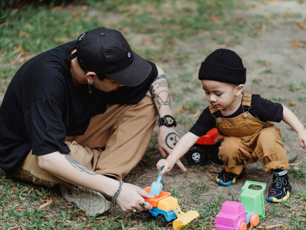 kid playing with his father in a park