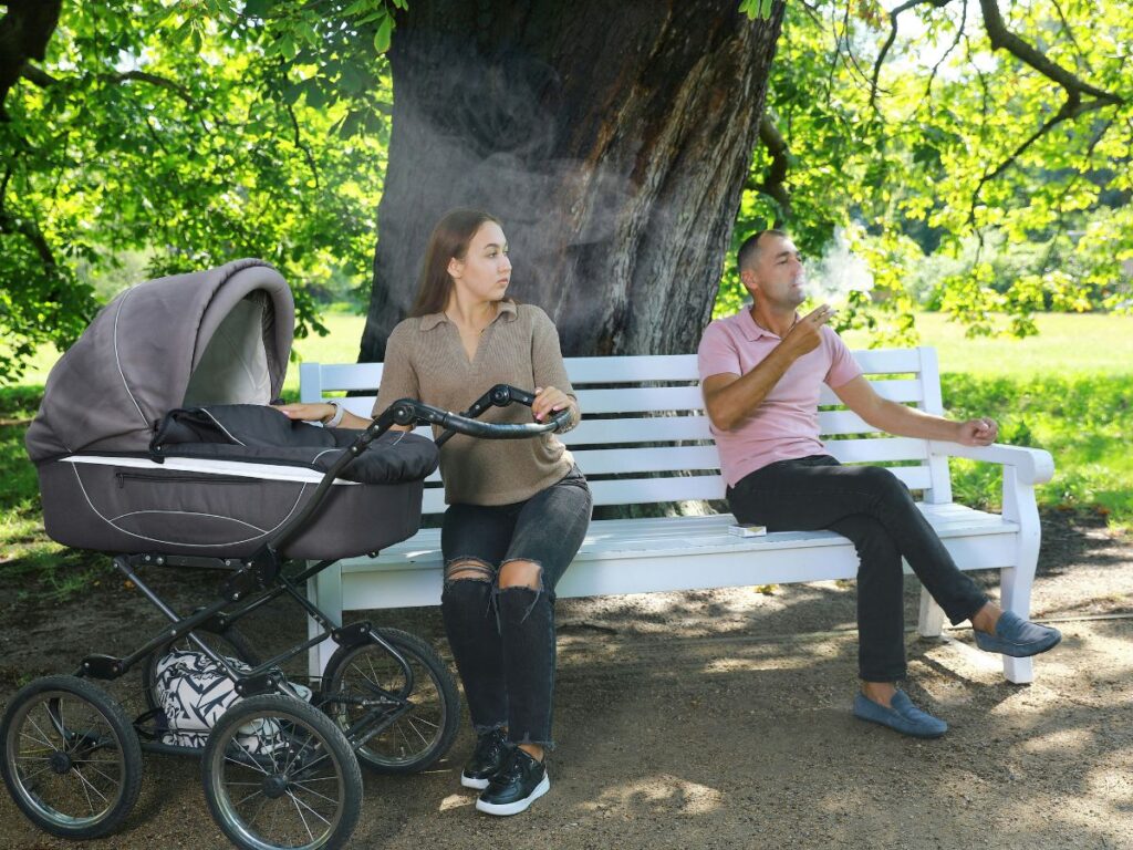 woman with her baby offended by a man in a park