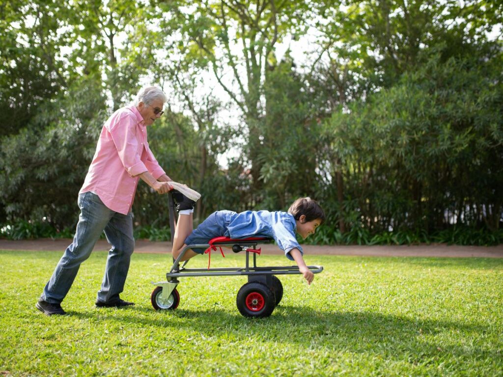 old man playing with a kid in park