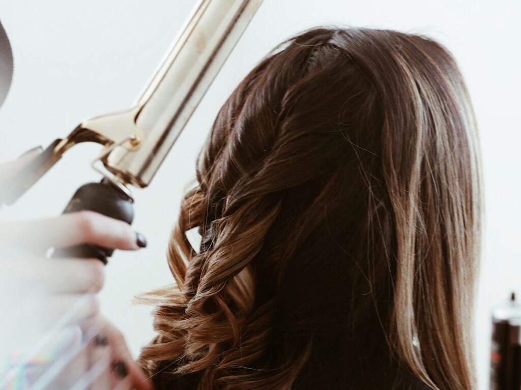 woman getting hair curled