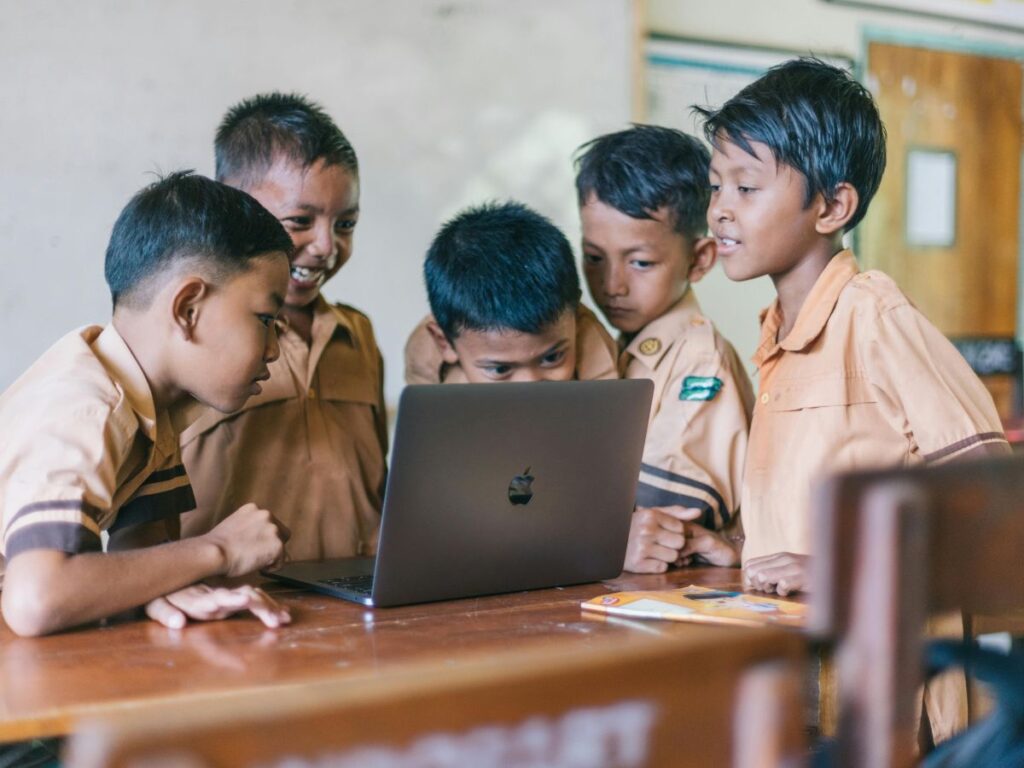 kids looking at laptop in school