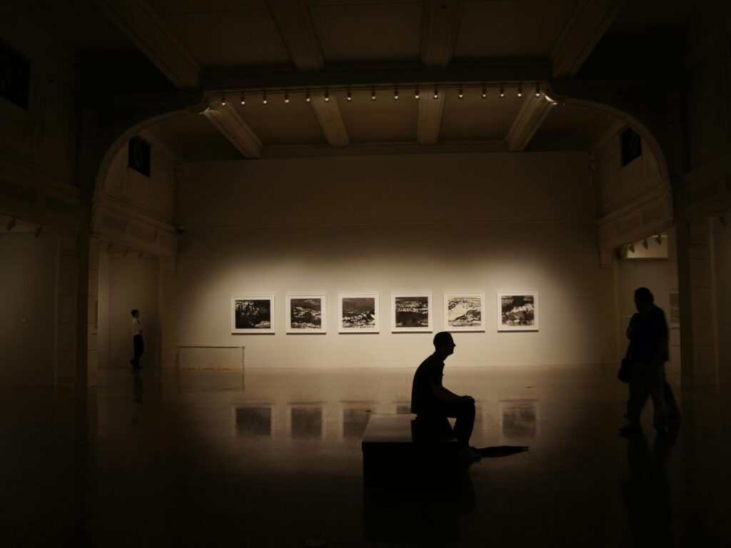 man sitting in an art gallery