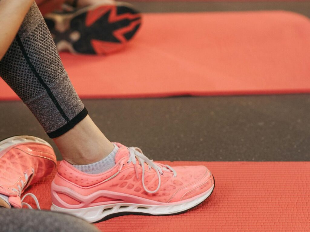 woman sitting on yoga mat