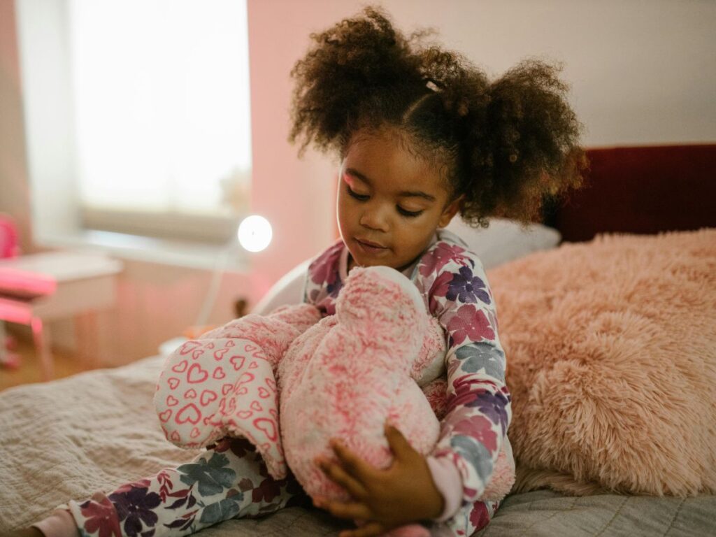 young girl playing with teddy