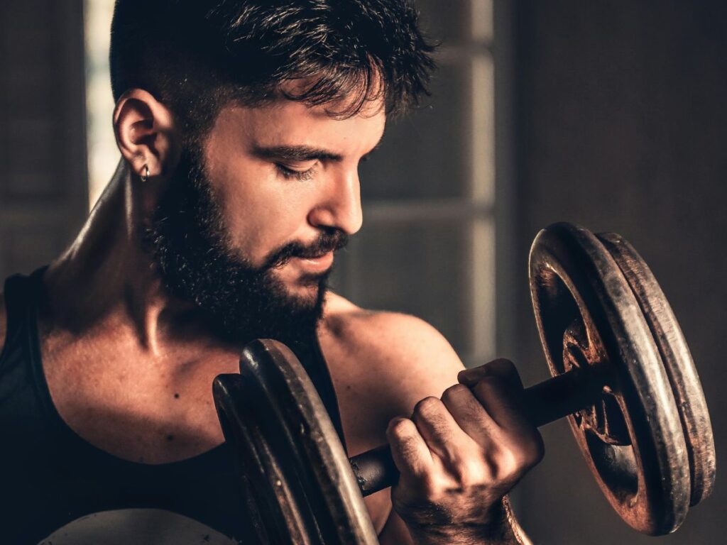 man lifting dumbbell