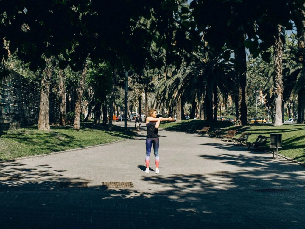 woman stretching in a park