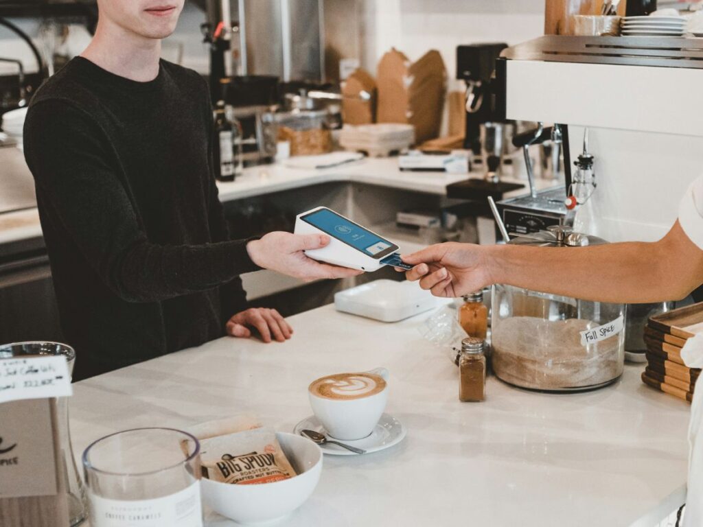 man paying in a bakery