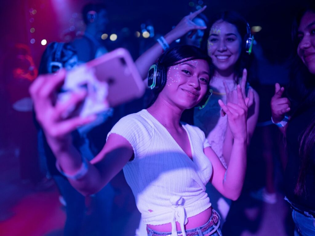 women taking selfie in a concert