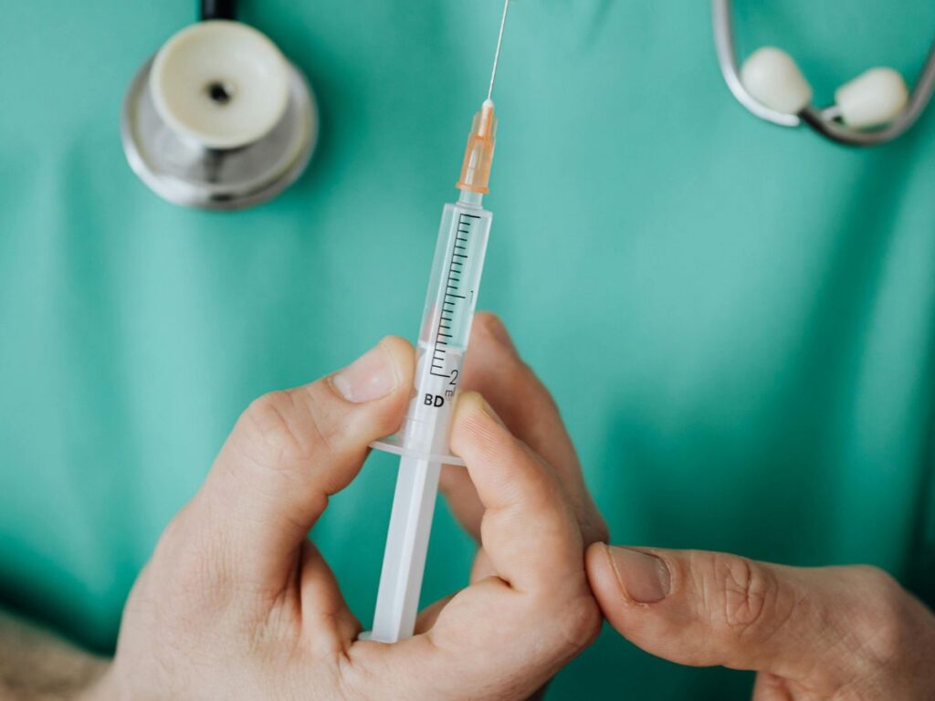 doctor holding injection