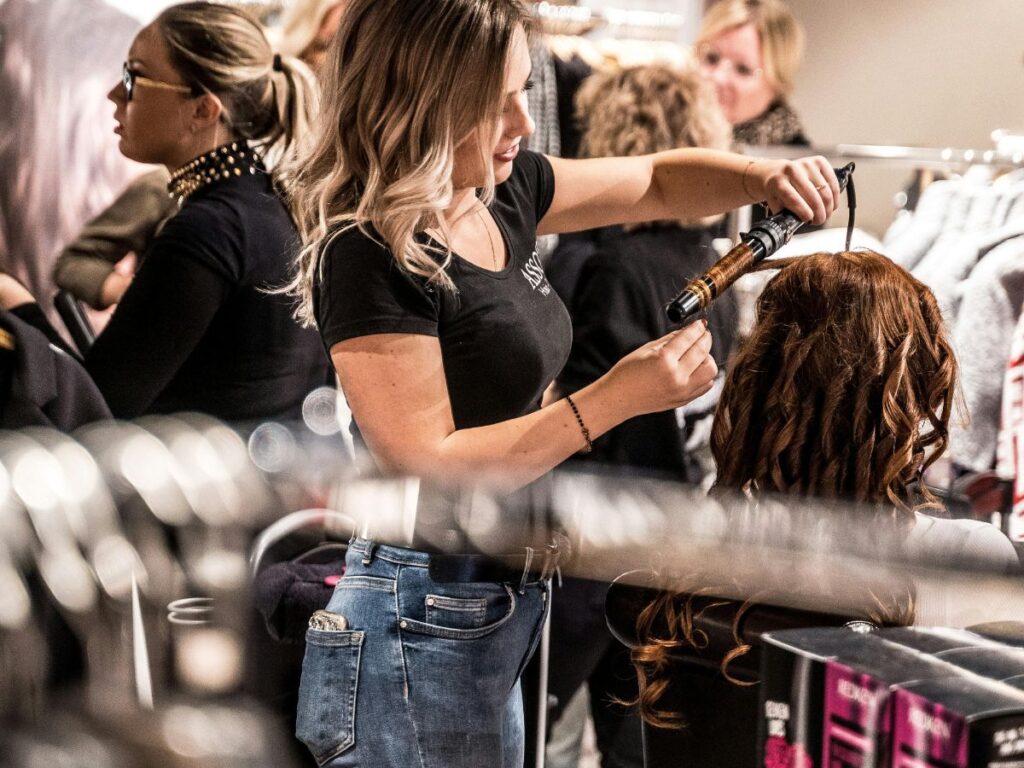woman getting hair curled