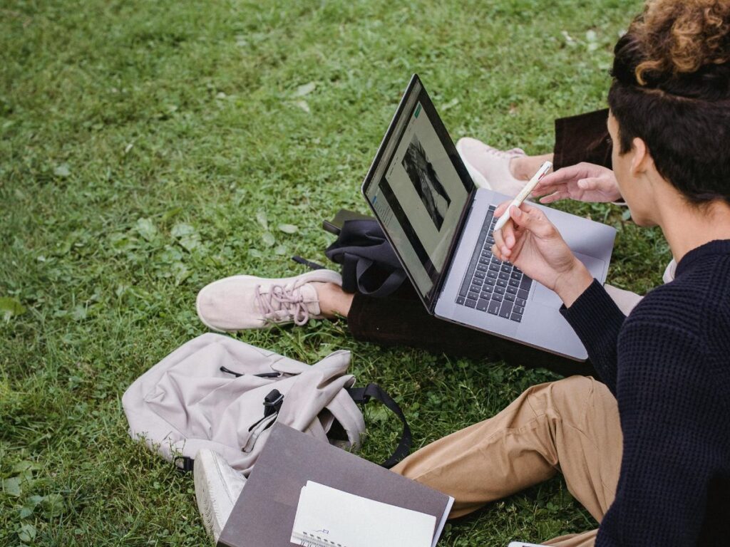 students sitting in university ground